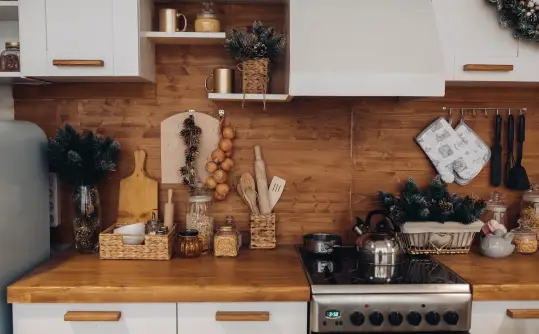 Modern kitchen with wooden countertops, organized utensils, and festive decor – ideal for showcasing BusyB's bond cleaning attention to detail in kitchens.