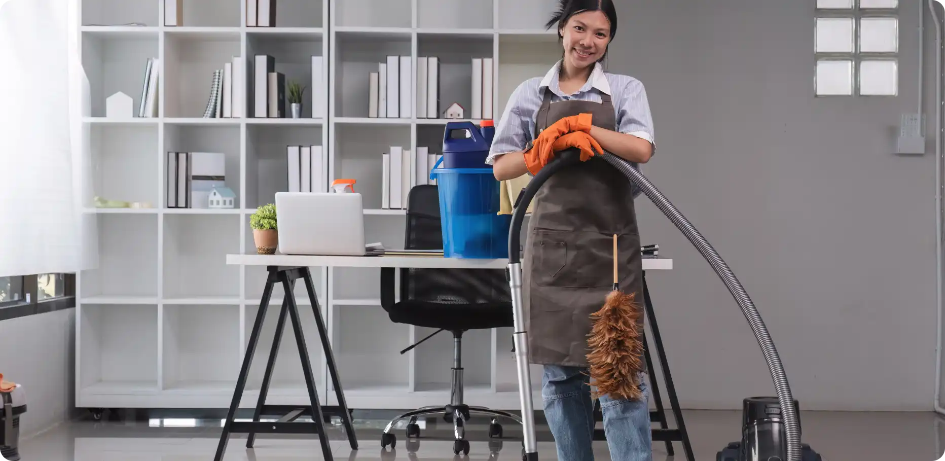 Professional cleaner with vacuum and cleaning supplies in a modern Australian office — Busy B Cleaning's trusted bond and carpet cleaning service 