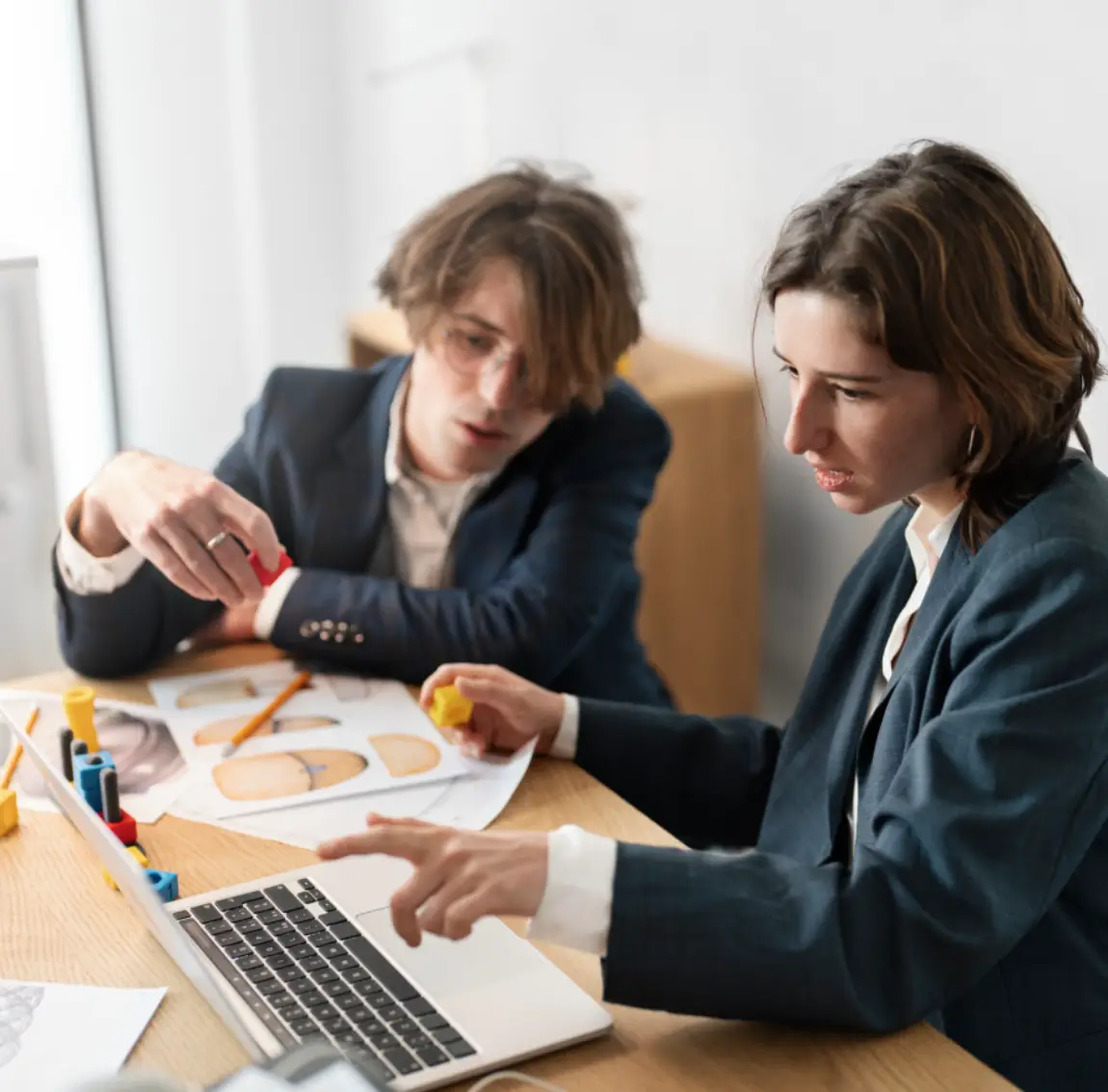 Team of professionals planning cleaning service strategies on laptop at Busy B Cleaning office